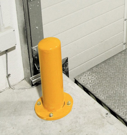 Protective bollards for sectional door guides